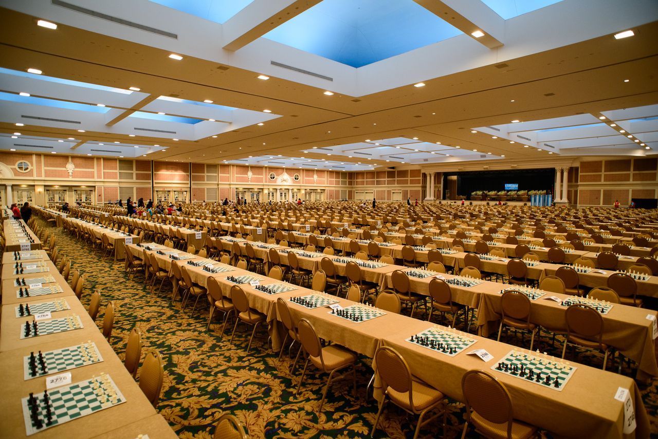 A large ballroom filled with chessboards